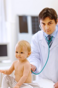 Cute baby being checked by a doctor using a stethoscope